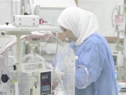 Nurse attends infant in hospital Stock Footage