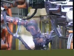 MS Robots working on cars in factory production line Stock Footage