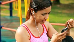 Attractive Asian with Music Stock Footage