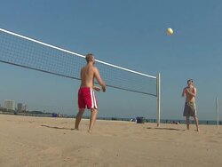 Two Men Playing Beach Volleyball Stock Footage