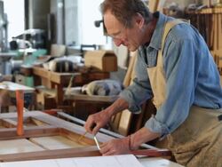 Caucasian father and son woodworkers working in their shop Stock Footage