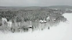 AERIAL: Cottages in snowy woods Stock Footage