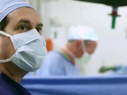 Doctors performing surgery in operating room Stock Footage