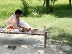 Farmer working on a laptop with his children playing  Stock Footage
