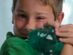 Boy Grabs and Hugs His Piggybank Stock Footage