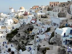 The white washed homes in the town of Oia with a view overlooking the Aegean Sea on the Island of Santorini, Greece, Europe Stock Footage
