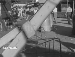 1952: COUNTY FAIR: TIMONIUM, MARYLAND:  HA WS (POV on Ferris wheel) Riding down from ferris wheel, people at county fair, tents. WS Father & son boarding onto gondolas of Ferris wheel. Carnival, funfair, fayre, festival, amusement park rides, ride Instructional Video