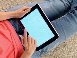 CU ZO Woman choosing book and turning pages on ipad / London, London, United Kingdom Stock Footage