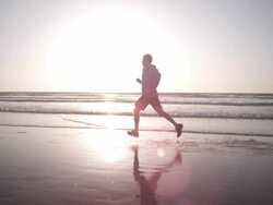 Jogging at the beach Stock Footage