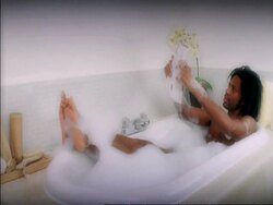 ZI man reading paper in bubble bath Stock Footage