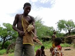 hadzabe-boy singing and playing a stringed instrument Stock Footage