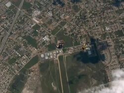 High Angle, Aerial - Skydivers free fall toward their landing target / USA Stock Footage