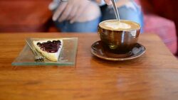 HD:Young woman drink coffee and cake blueberry pie in coffee house Stock Footage