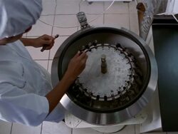 Medium shot lab technician loading tubes into centrifuge / Bandung, Indonesia Stock Footage