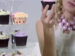 Young woman eating cupcake Stock Footage