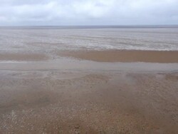 Low aerial across Heacham Beach at low tide Stock Footage