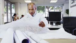 Businessman examining blueprints in office Stock Footage