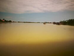 WS T/L POV View of Boat pulls away from jetty, heads out under bridge and settles mid river with houses on both bots / Hoi An, Vietnam Stock Footage