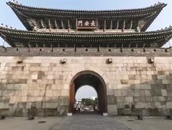 MS T/L POV View of Suwon Hwaseong Castle Janganmun Gate (Unesco World Heritage) and Entering Gate with crowded area / Suwon, Gyeonggi do, South Korea Stock Footage