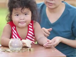 Cute boy with mother learn to count money Stock Footage