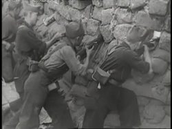 Soldiers shoot from behind sand bags during the Spanish Civil War. News Clip