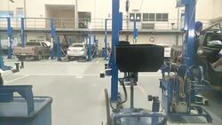 Mechanics repair cars which stand in garage, time lapse Stock Footage