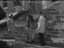 1946: RED CROSS: PHYSICAL THERAPY:  EXT WS Nurse & doctor watching disabled male walking down steps w/ crutches. VS Supervising male walking up steps w/ crutches. Crutch, mobility aids Instructional Video