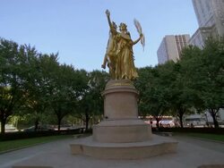 Low angle wide shot flock of pigeons flying off statue of General Sherman in Central Park / New York City Stock Footage