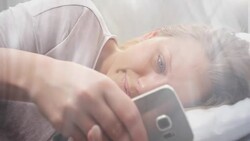 People waking up - Young Woman Texting in Bed Stock Footage