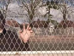 Teenager / Hoody staring through fence - HD &amp; PAL Stock Footage