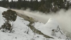 Steam from a hot spring drifts by snow. Stock Footage