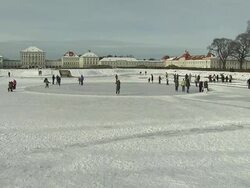 Schloss Nymphenburg, people on ice skates, snow, frozen river, castle in background, panning shot, pull focus Stock Footage