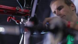 Bicycle mechanic twists 3-way Allen wrench in bike repair shop Stock Footage