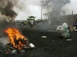 WS View of men burning plastic from electric cables to recover copper and others scavenging scrap metal / Lagos, Nigeria Stock Footage