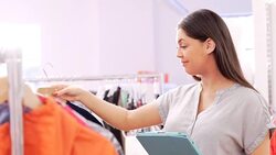 Clothing shop owner checking inventory with digital tablet Stock Footage