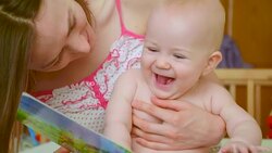 child plays with children's picture book Stock Footage