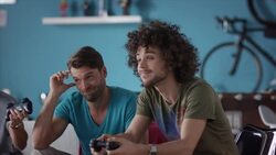 Guys sitting on couch playing video games Stock Footage