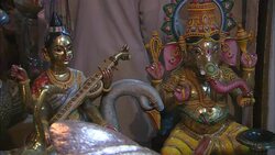 Ornate Hindu idols decorate a booth in an Indian market. Stock Footage