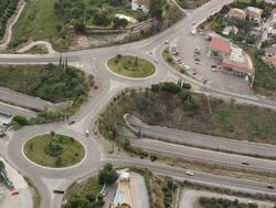 aerial view of freeway entrance with two roundabouts Stock Footage