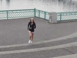WS SLO MO Shot of young female jogger runs up concrete steps on city waterfront  / Portland, Oregon, United States  Stock Footage