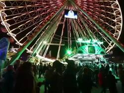 MS LA TD TU Shot of Ferris wheel and people passing by at fun fair / Cologne, Germany Stock Footage