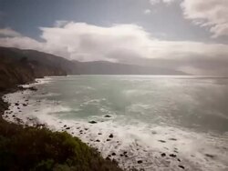 WS  T/L  View of Clouds moving in sky and waves hiting rocks / Big Sur, California, United States Stock Footage
