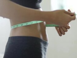 Measuring waistline of a beautiful body in inches  HE Stock Footage