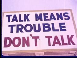 1950s CU LA Sign reading 'Talk Means Trouble Don't Talk' at Camp Desert Rock at Nevada Test Site / Nye County, Nevada, USA Stock Footage