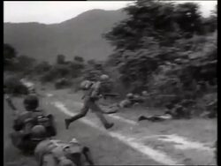 B/W 1960's soldiers with guns lying on ground in battle / Vietnam / SOUND Stock Footage