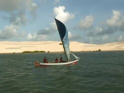 MS POV TS Three people travelling through sailing boat at island with mountains of sand / Ilha dos Lencois, Maranhao, Brazil Stock Footage