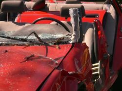 Firefighters on rescue site demolishing wrecked car after accident Stock Footage