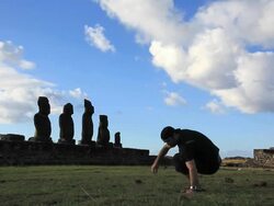 HD video of a man sitting close to moais Stock Footage