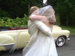 MS Groom lifting bride and spinning her around near classic convertible / Washington State, USA Stock Footage