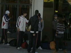 High Speed Driving past adolescents in street, Spain Stock Footage